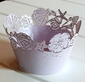 Close-up of laser-cut cupcake wrappers with ocean shell patterns in pearlescent purple - 5cm / Light Purple