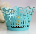 Detail of light blue laser-cut cupcake wrappers with floral garden and bird patterns - Tiffany Blue