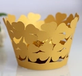 Macro view of gold laser-cut four-leaf clover cupcake wrapper with a chocolate - 5cm / Gold Yellow