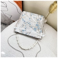 Detail of vintage beige bucket bag with blue floral embroidery and pearl handle strap - Blue