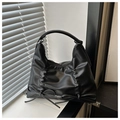 Detalle de un bolso Hobo negro con textura plisada y elegantes adornos de lazos - Negro