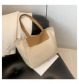 Large beige and khaki patchwork PU tote bag with FASHION lettering on a leather chair - Khaki