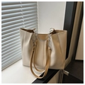 Detail of the cream PU leather tote bag with pleated sides and chain strap outdoors - Khaki (Without Charm)