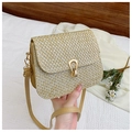 Detail view of woven straw crossbody bag with golden clasp and leather strap - Khaki