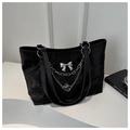 Detail of black velvet tote bag featuring a silver metal chain and 3D bow decoration - Black