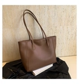 Detail of deep brown tote bag with smooth leather texture and elegant shoulder strap - Brown