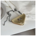 Close-up of a mini triangle metallic bag with silver bow buckle and elegant chain strap - Gold