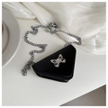 Detailed close-up of a mini triangle bag with a silver butterfly clasp and metal chain - Black