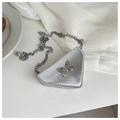 Close-up of silver triangular mini bag with metallic bow detail and chain strap - Silver