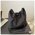 Close-up of black nylon bucket bag with drawstring closure and adjustable wide strap - Black Without Pendant