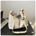 Detail of cream nylon bucket bag with drawstring closure and adjustable wide shoulder strap - Khaki Without Pendant