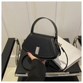 Minimalist black leather trapezoid crossbody bag with a silver rectangular metal clasp - Black