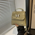 Fashionable sage green pleated bucket bag with a silver metallic butterfly clasp detail - Green
