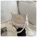 Cream PU leather crossbody bag with golden bow hardware and knotted handle design - White