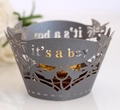 Macro detail of 'it's a boy' laser-cut paper cupcake wrapper with floral hollow patterns - Silver Charcoal