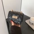 Black quilted mini crossbody bag with gold chain strap and metal turn-lock closure - Black