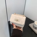 Elegant cream quilted mini chain bag with gold twist lock for crossbody or shoulder wear - Off White