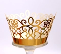 Intricate laser-cut gold lace cake wrapper with heart patterns on a glass cup - Reflective Gold