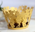 Laser-cut gold cupcake liners featuring intricate vine and leaf patterns for baking - Gold