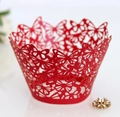 Detail of red laser-cut cupcake wrappers with elegant butterfly patterns for party decor - Pearlescent Red