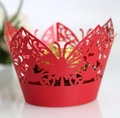 Close-up of pink laser-cut butterfly cupcake wrapper with intricate hollow lace details - Pearlescent Red