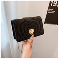 Detail of black velvet heart quilted handbag with gold heart lock and chain strap - Black