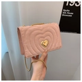 Detailaufnahme der rosa Herz-Stepptasche aus Leder mit goldenem Herzverschluss und Kette - Rosa