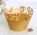 Detail of laser-cut gold cupcake wrapper with vintage filigree vine pattern - Gold