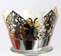 Macro view of laser-cut silver butterfly cupcake wrapper with gold foil chocolate - Reflective Silver