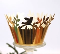 Intricate laser-cut golden cupcake wrapper featuring elegant bird and leaf patterns - Reflective Gold