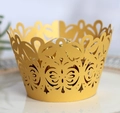 Golden laser-cut hollow cake wrapper with floral patterns on white plate - Gold