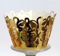 Laser-cut gold cupcake wrappers with intricate floral lace patterns for wedding party decor - Reflective Gold