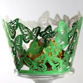 Pearly green laser-cut butterfly cupcake wrapper surrounding a gold wrapped candy - Reflective Green
