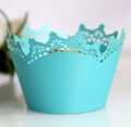 Macro view of laser-cut crown lace cupcake wrappers in elegant tiffany blue pearlescent paper - Tiffany Blue