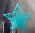 Close-up of laser-cut turquoise glitter star place card on a wine glass rim - Tiffany Blue