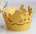 Detail of yellow laser-cut duck cupcake wrapper with smooth matte paper texture - Gold