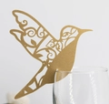 Detail of golden laser-cut hummingbird place card on a glass rim for weddings - Beige Gold