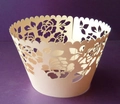 Macro view of laser-cut rose floral pattern on cream-colored paper cupcake wrapper - Jade Pearl