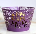 Detail of laser-cut purple Halloween cupcake wrapper with skull and spider web motifs - Dark Purple