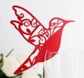 Elegant red laser-cut hummingbird place card decoration on a clear wine glass rim - Pearlescent Red