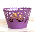 Close-up of purple laser-cut lace cupcake wrappers with elegant rose patterns - Dark Purple