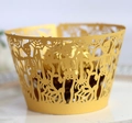 Detail of golden laser-cut Halloween cupcake wrapper with skull and spider web motifs - Gold