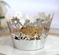 Silver laser-cut floral cupcake wrappers on white ceramic plate for dessert table decor - Reflective Silver