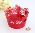 Detail of red laser-cut cupcake wrapper featuring intricate lace floral patterns - Pearlescent Red