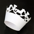 Detail of laser-cut white paper cupcake wrappers with rocking horse and bear patterns - White