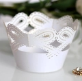 Elegant white laser-cut cupcake wrappers with lace crown pattern and hollow bow details - White