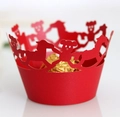 Macro shot of red laser-cut cupcake wrapper with teddy bear and horse pattern - Pearlescent Red