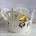 Laser cut white cupcake wrapper featuring a royal carriage and crown design for parties - Ivory