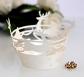 Detail of white laser-cut cake wrappers with reindeer and snowflake patterns for weddings - Ivory