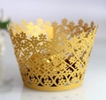Detail of gold laser-cut cupcake wrapper with intricate floral and heart-shaped hollow patterns - 5*5*8CM / Gold
